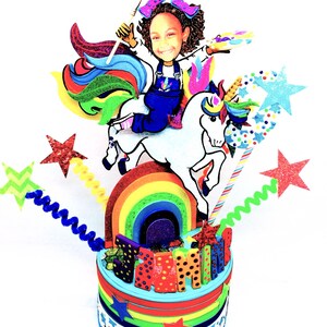 May include: A vibrant birthday cake with a unicorn theme. The cake features a cartoon girl riding a white unicorn over a rainbow. The cake is decorated with stars, the name "SAMI", and colorful layers.