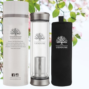 May include: A white insulated travel mug with a black tree logo and the text "UENDURE" and the text "Premium 14oz Glass Infuser Bottle for loose leaf tea, cold brew coffee & fruit. Made of double walled insulated glass, twist off stainless steel lids and a removable infuser. Travel sleeve included."  Next to the mug is a clear glass bottle with a stainless steel lid and a stainless steel infuser. The bottle also has a black tree logo and the text "UENDURE".  A black travel sleeve with a black tree logo and the text "UENDURE" is next to the bottle.