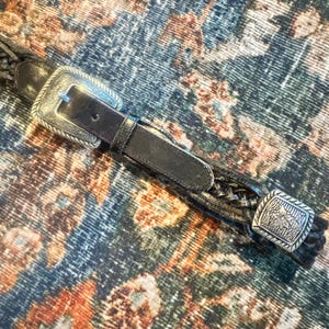 Vintage Western Black Braided Belt with Silver Floral Tooled Concho Adornments around it