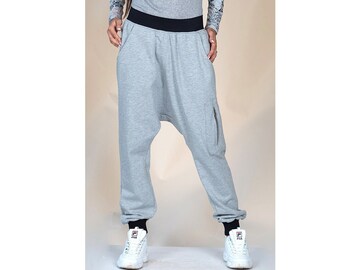 May include: Gray sweatpants with a black waistband and a zippered pocket on the right leg.