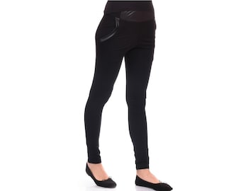May include: Black leggings with a faux leather detail on the back pocket. The leggings are fitted and have a slim leg.