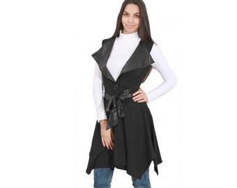 May include: A black sleeveless vest with a faux leather collar and a matching belt. The vest has a button closure and a slightly flared hem.