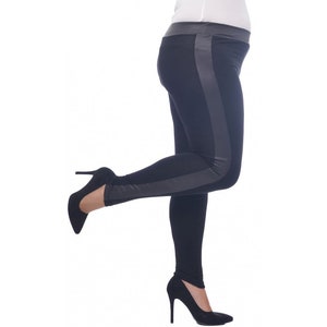 May include: Black leggings with a gray stripe down the side. The leggings are worn by a person with one leg raised and wearing black high heels.