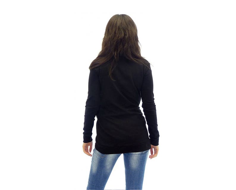 May include: A black long-sleeved shirt with a mock neck and a relaxed fit. The shirt is paired with blue jeans.
