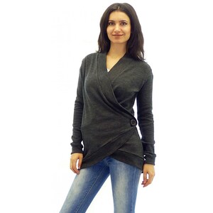 May include: A charcoal gray wrap cardigan with a single button closure. The cardigan has a long sleeve and a v-neck.