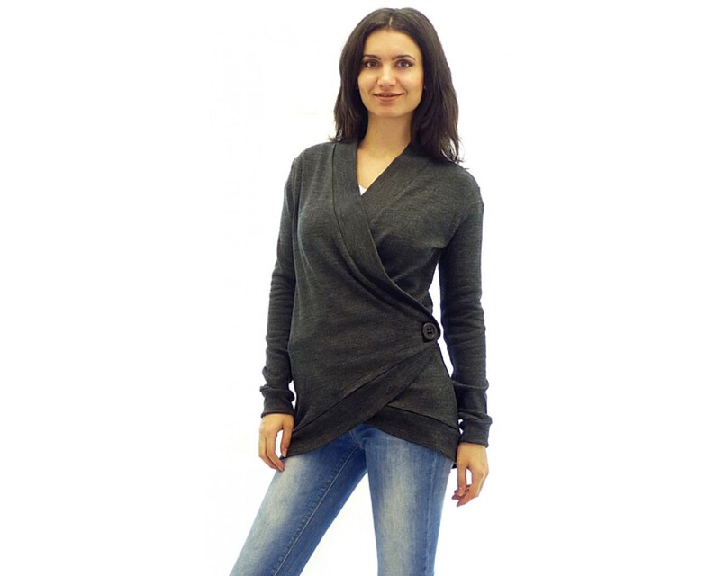 May include: A charcoal gray wrap cardigan with a single button closure. The cardigan has a long sleeve and a v-neck.