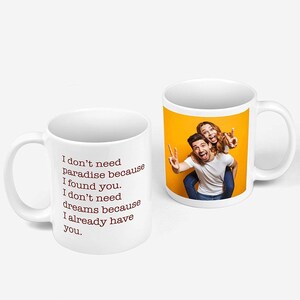Puede incluir: Taza de cer&aacute;mica blanca con una pareja en la parte posterior, el hombre est&aacute; haciendo un signo de paz y la mujer est&aacute; haciendo un signo de paz con su brazo alrededor del hombre. La parte delantera de la taza tiene el texto "No necesito el para&iacute;so porque te encontr&eacute;. No necesito sue&ntilde;os porque ya te tengo."
