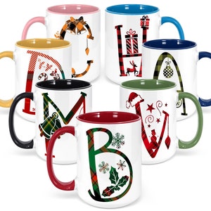 May include: Set of 7 ceramic mugs with a Christmas theme. Each mug features a different letter of the alphabet with a plaid pattern and a Christmas-themed design. The mugs have a contrasting color inside.