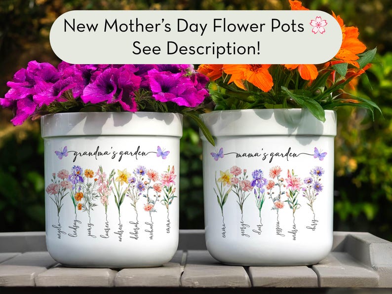 May include: Two white ceramic flower pots with floral designs and the text "grandma's garden" and "mama's garden". The pots are filled with vibrant purple and orange flowers. The top banner reads "New Mother's Day Flower Pots See Description!"