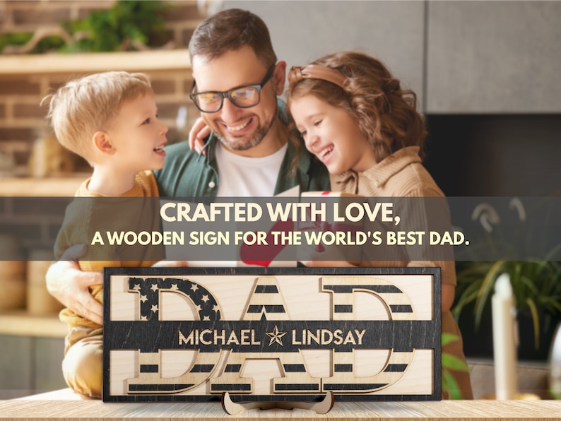 May include: A wooden sign with the text "CRAFTED WITH LOVE, A WOODEN SIGN FOR THE WORLD'S BEST DAD." The sign is decorated with an American flag pattern and the words "DAD" are in large, bold letters. The sign also includes the names "MICHAEL" and "LINDSAY" in smaller letters.