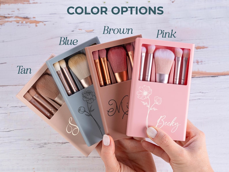 May include: A collection of makeup brush sets in tan, blue, brown, and pink cases. Each case is personalized with a name or initial and features a floral design. The cases are open, revealing the brushes inside.