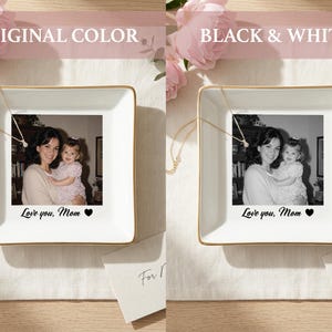 May include: A square white ceramic trinket dish with a gold-toned rim featuring a custom photo of an adult and a child. The text "Love you, Mom" followed by a black heart icon is printed below the photo. A delicate gold chain rests on the dish.