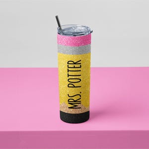 May include: A glittery pencil-themed tumbler with a black straw. The tumbler has pink, silver, and yellow sections, with "MRS. POTTER" printed vertically in black. The bottom is black.