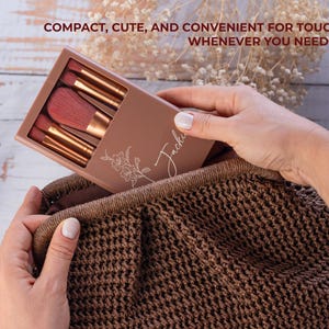 May include: A makeup brush set in a brown case with the name "Jackie" and a floral design. The case is held in a brown woven bag. The text "COMPACT, CUTE, AND CONVENIENT FOR TOUCH-UPS WHENEVER YOU NEED THEM." is at the top.