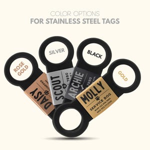 May include: Five stainless steel dog tags with different colored rings. The tags are labeled with the names "Daisy", "Scout", "Archie", "Molly", and "Gold".