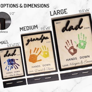 May include: Wooden plaques with black frames and the words "Best Dad Ever" and "Best Grandpa Ever". Each plaque features handprints and the phrase "Hands Down". Sizes include 5.5"x7.25", 7.5"x10", and 10.5"x14".