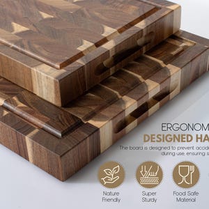 May include: Two wooden chopping boards with a brown and tan checkerboard design. Each board has a groove around the edge and a handle cut-out. The text "ERGONOMICALLY DESIGNED HANDLE" is visible.