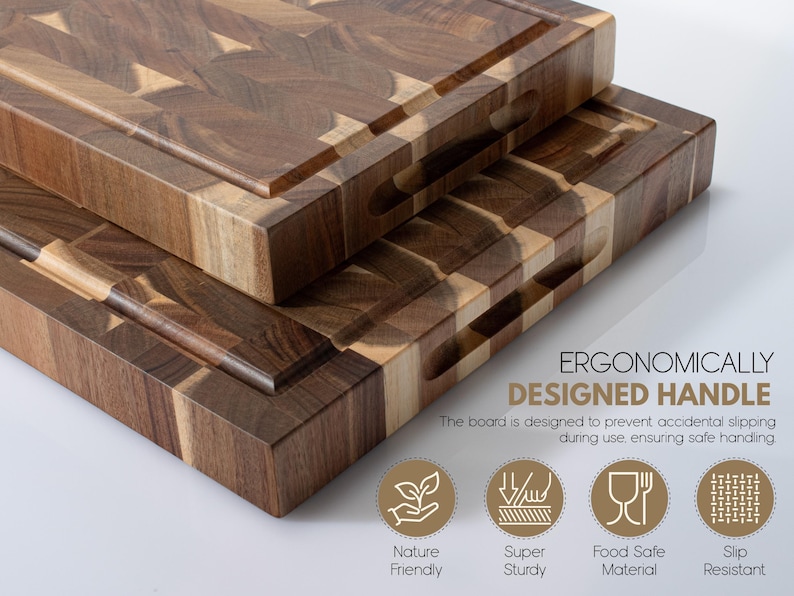 May include: Two wooden chopping boards with a brown and tan checkerboard design. Each board has a groove around the edge and a handle cut-out. The text "ERGONOMICALLY DESIGNED HANDLE" is visible.