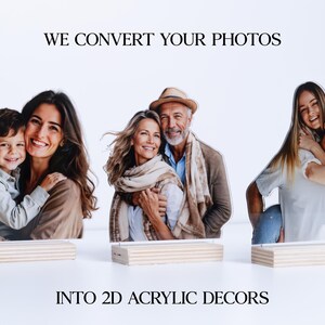 May include: Acrylic photo decor featuring three family portraits. The text reads "WE CONVERT YOUR PHOTOS INTO 2D ACRYLIC DECORS." Each portrait is mounted on a wooden base, showcasing a family of three, a couple, and a couple with a piggyback ride.