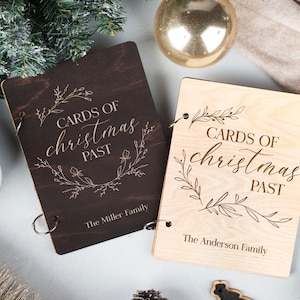 May include: Two wooden photo albums with the text "Cards of Christmas Past" and the names "The Miller Family" and "The Anderson Family" engraved on the front.