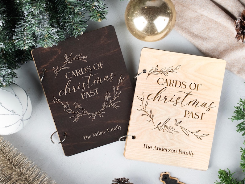 May include: Two wooden photo albums with the text "Cards of Christmas Past" and the names "The Miller Family" and "The Anderson Family" engraved on the front.