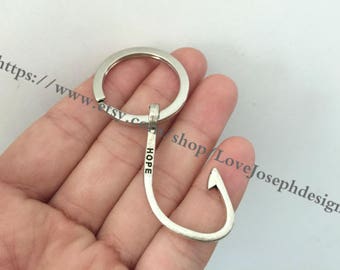May include: Silver key chain with a hook and the word "HOPE" engraved on the hook.