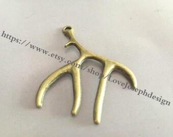 May include: A gold-toned metal antler charm with a loop at the top for attaching to jewelry or crafts.