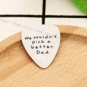 Può includere: Un plettro per chitarra in argento con la scritta "We couldn't pick a better Dad" incisa su di esso.