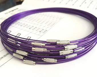 May include: A stack of purple metal necklaces with silver clasps. The necklaces are made of thin wire and are approximately 18 inches in length.