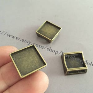 vendita all'ingrosso 50 pezzi/lotto bronzo antico placcato 15mm quadrati scorrevoli braccialetti cabochon vassoi castone ciondoli