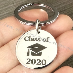 May include: Silver keychain with a round tag that says "Class of 2020" and a graduation cap graphic.