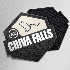 May include: A black and white patch with the words "CHIVA FALLS" in bold white letters. The patch features a map outline and the letters "AZ" in a circle. The patch is hexagonal and has a textured black backing.