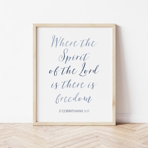 May include: A framed print with a white background and a blue inscription that reads "Where the Spirit of the Lord is there is freedom" with the scripture reference "2 Corinthians 3:17" below the text.