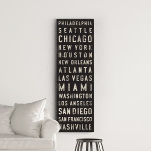May include: Black and white graphic print of city names, including Philadelphia, Seattle, Chicago, New York, Houston, New Orleans, Atlanta, Las Vegas, Miami, Washington, Los Angeles, San Diego, San Francisco, and Nashville.