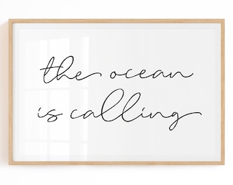 May include: A framed print with the text "the ocean is calling" in a simple, handwritten font.