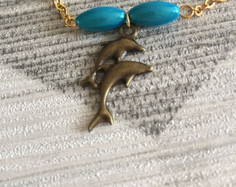 Gold and blue dolphin charm bracelet, stackable bracelets, sea life theme bracelet, gift for summer birthdays, summer jewellery style,