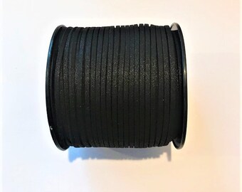 May include: A spool of black leather cord, wound tightly and ready for crafting projects.