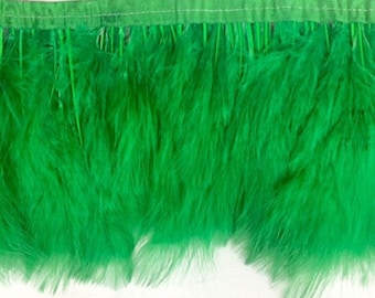 May include: Green feather trim with a sewn edge. The trim is made of soft, fluffy feathers.