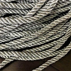 May include: Silver metallic braided rope, a decorative trim for crafts and home decor projects.