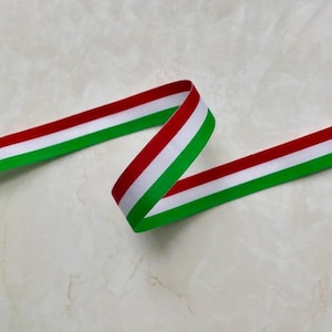 May include: A green, white, and red ribbon with a slight curve. The ribbon is a patriotic color scheme.