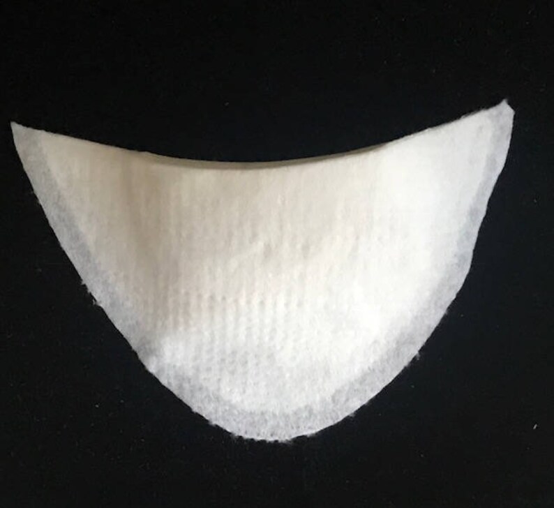May include: White fabric shoe insert with a curved shape.