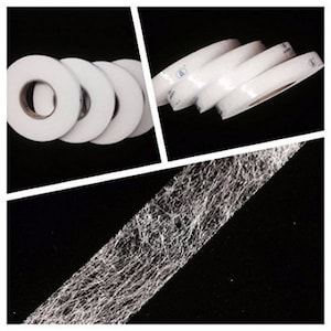 May include: Close-up of white adhesive tape rolls. The tape is a woven fabric with a white adhesive backing. The tape is used for bonding fabrics together.