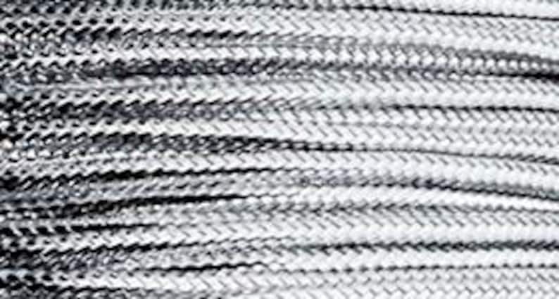 May include: Close-up of a silver-colored metal wire coil. The wire is twisted and has a textured surface.