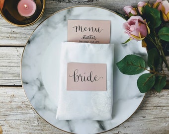 Blush pink escort cards place settings