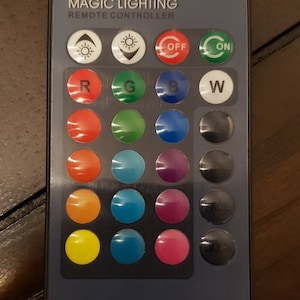 May include: A remote control for magic lighting with buttons for on, off, fade, smooth, red, green, blue, white, and various color options.