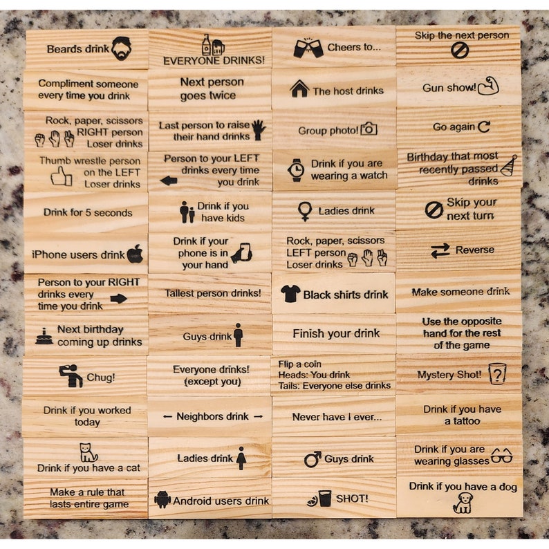 May include: A wooden drinking game with various instructions printed on individual blocks. Instructions include "Everyone drinks!", "Drink if you have a cat", and "Skip the next person". The game is designed for group participation.