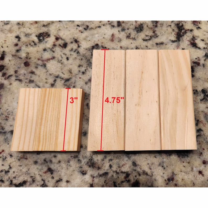 May include: A collection of unfinished wooden blocks. One block measures 3 inches, while the longer blocks are 4.75 inches in length. The natural wood grain is visible on the surface of the blocks.