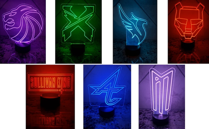 May include: A collection of 7 different neon signs with various designs, including a lion, an X, a bird, a bear, a word, a letter A, and a symbol. The signs are illuminated in different colors, including purple, green, blue, red, and pink.