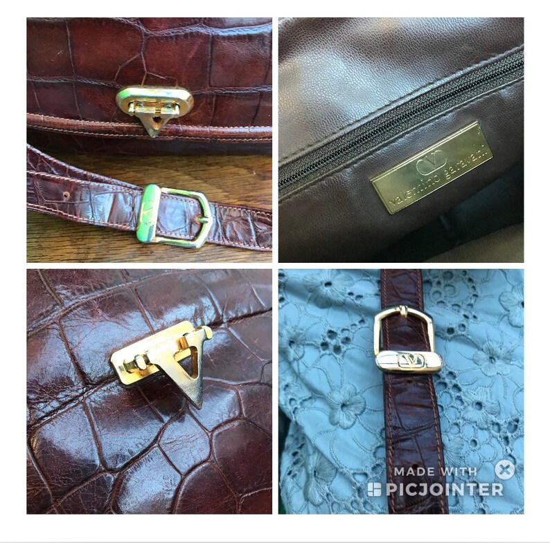 Op de afbeelding: Bruine leren handtas met een krokodillenleertextuur. De tas heeft goudkleurige hardware, waaronder een sluiting en een gesp. De binnenkant heeft een gouden label met de tekst "Valentino Garavani".