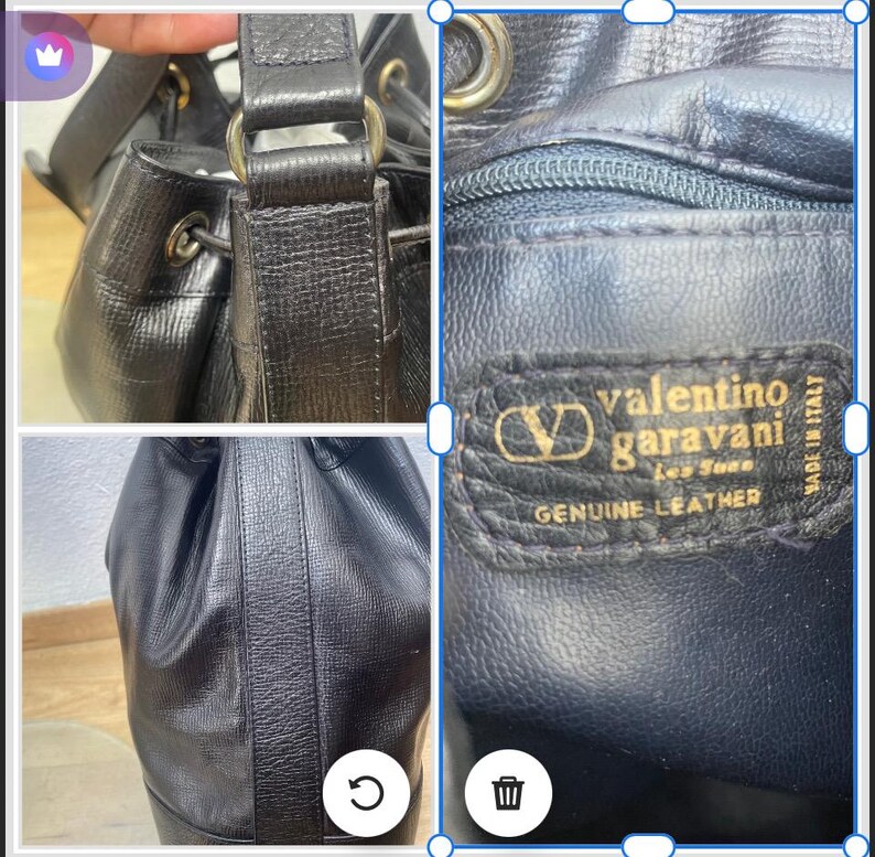 May include: Black leather Valentino Garavani bucket bag. The bag features a drawstring closure, gold-tone hardware, and a textured exterior. The interior label reads "Valentino Garavani, Genuine Leather, Made in Italy."